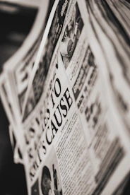 Close-up of a Tamil newspaper with bold headlines on politics and sports.