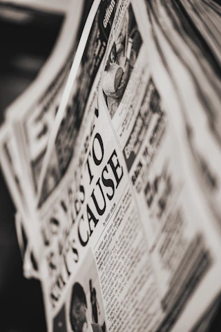 A close-up of a printed newspaper edition with the headline clearly visible.