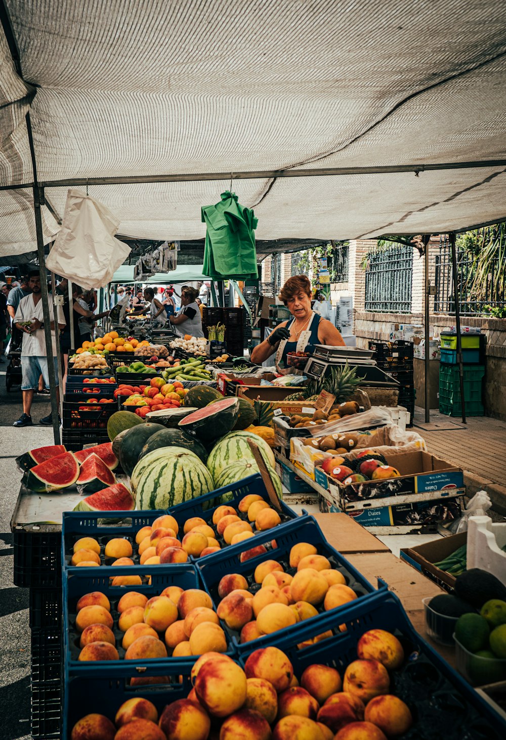 a person selling fruits at an outdoor market