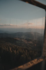 A serene forest view from a luxury room balcony at Vantara Resorts during golden hour.