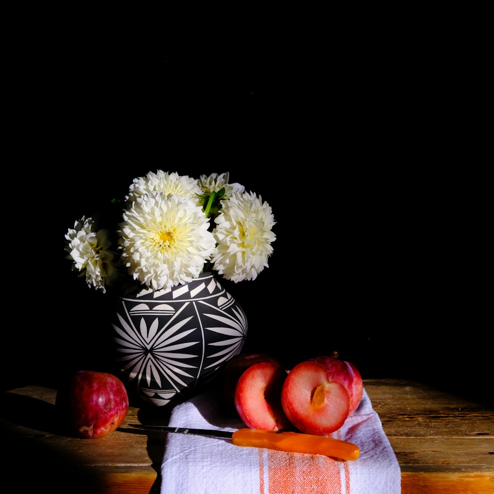 a hand holding a vase with flowers