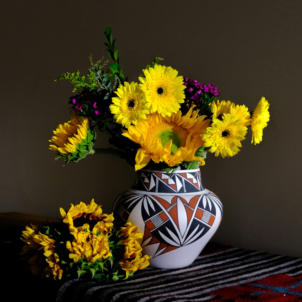 a vase of yellow flowers