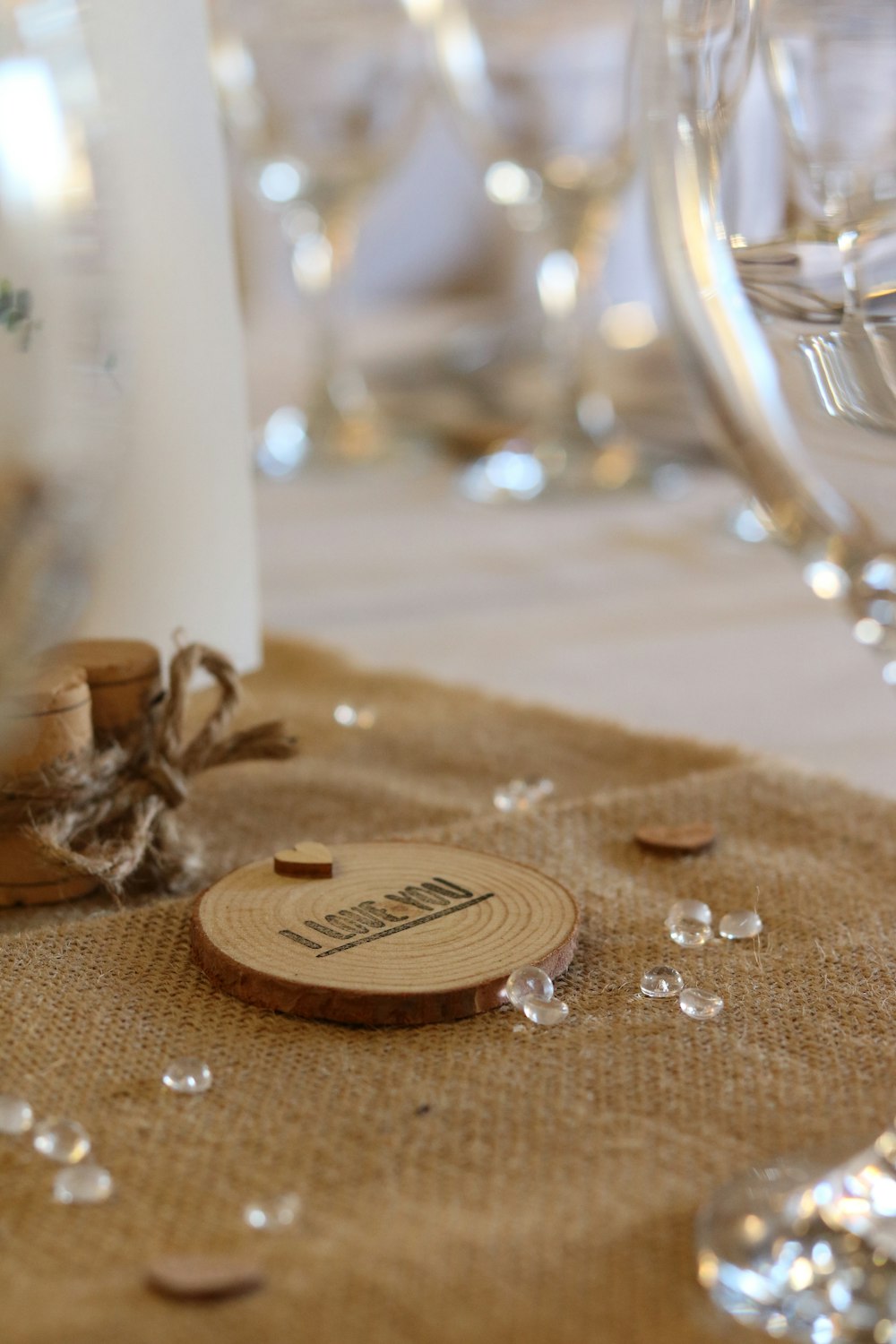 a close-up of a table with a gold ring and a glass