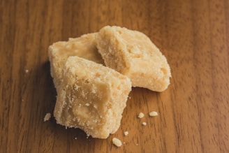 a couple pieces of bread on a wooden surface