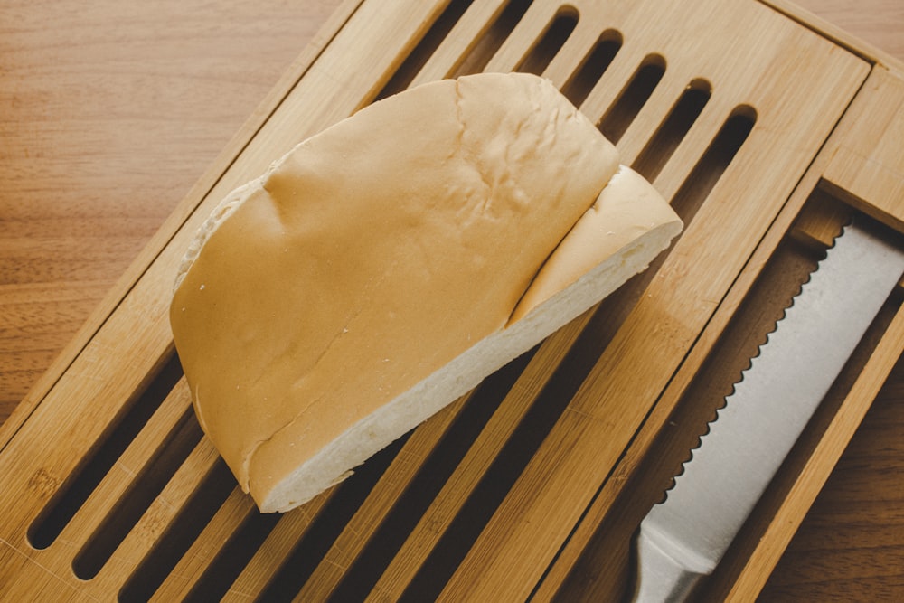 a block of cheese on a wooden board