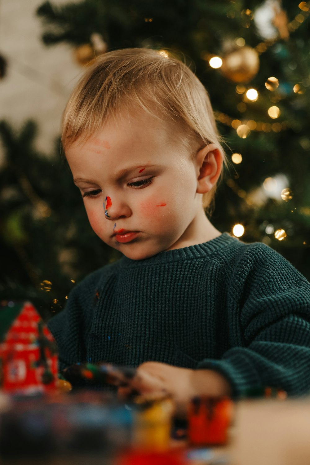 a child looking at a christmas tree