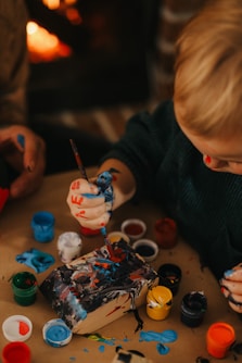 a child painting on a table