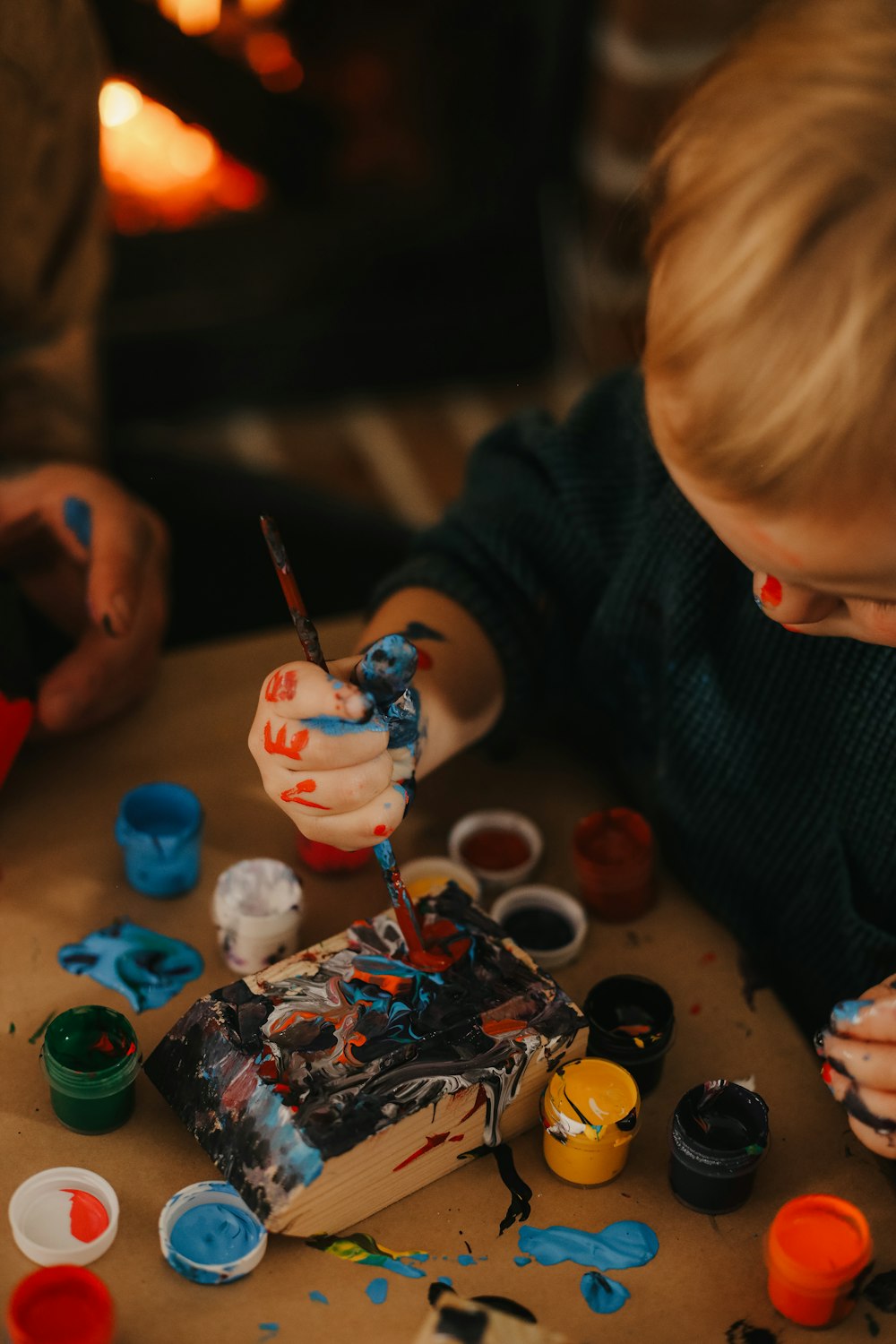 a child painting on a table