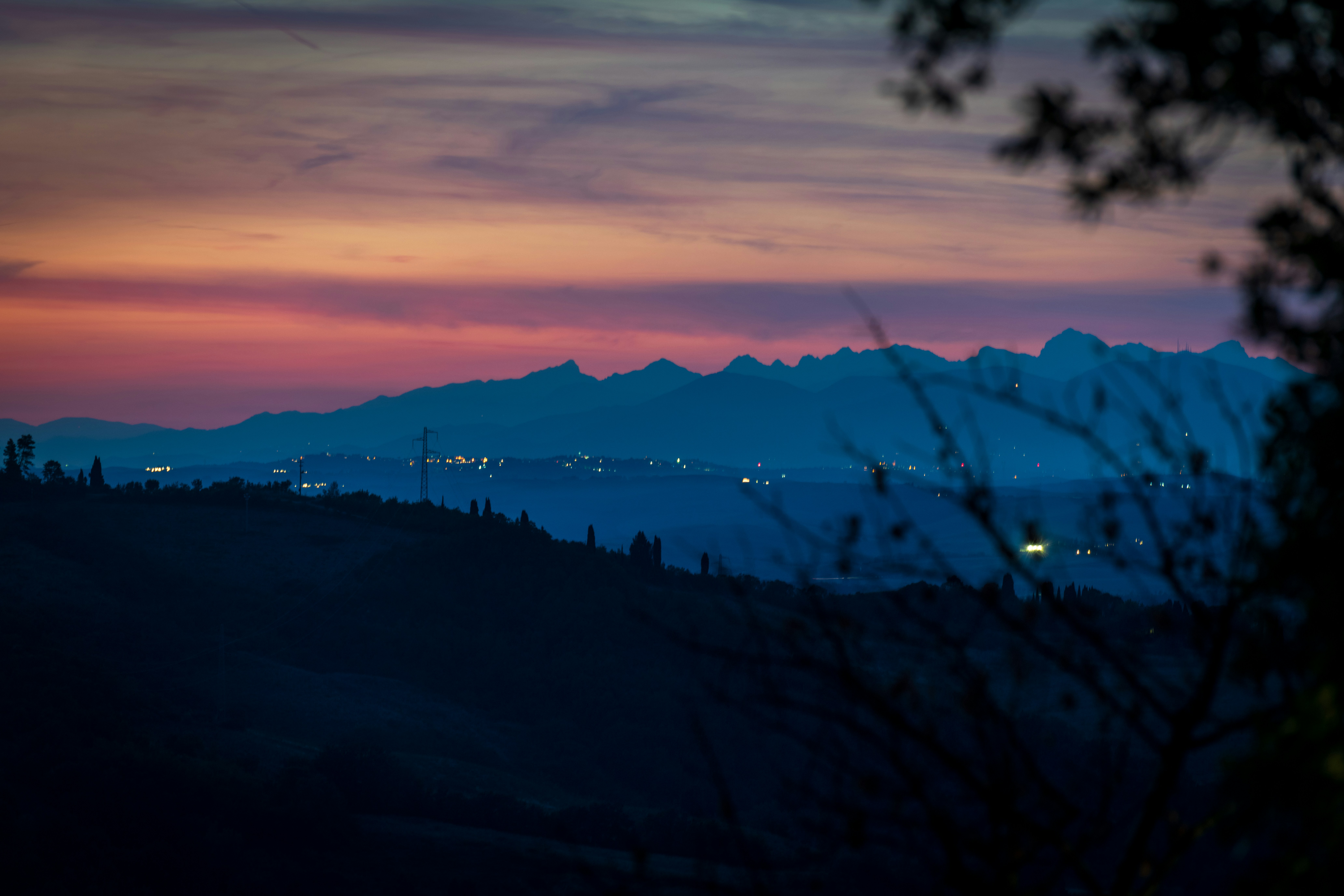 A landscape with trees and a sunset