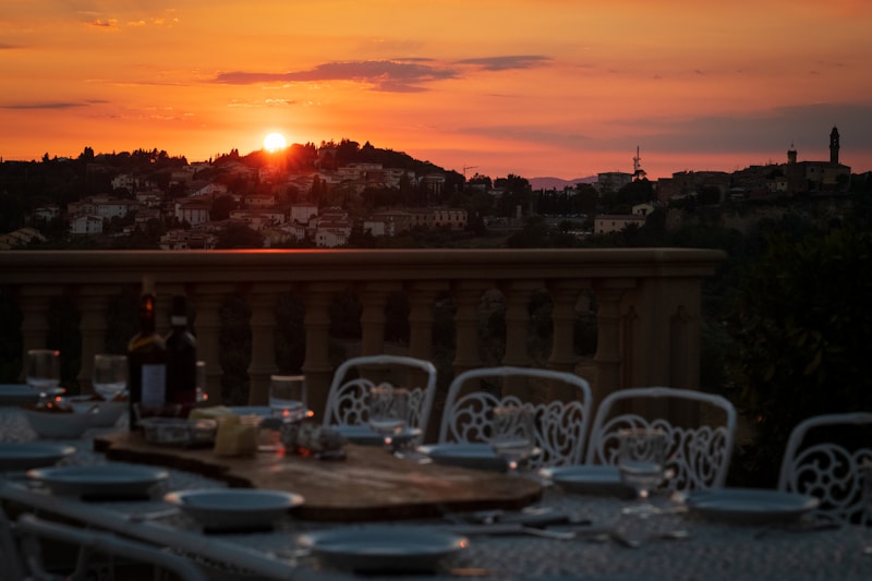 a table with chairs and a sunset