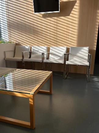 Modern waiting area, featuring charcoal seating and subtle silver details.