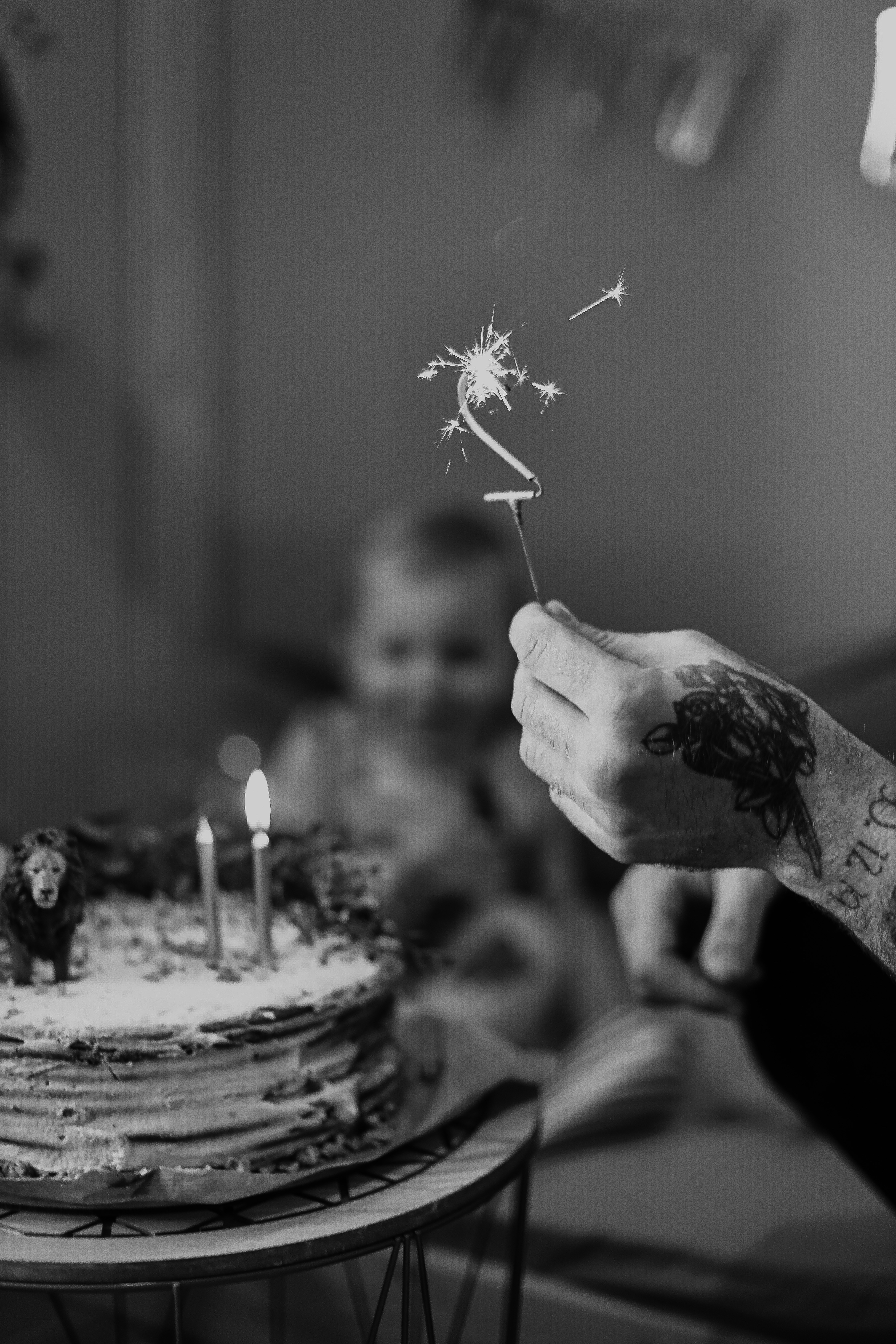a person lighting candles on a cake