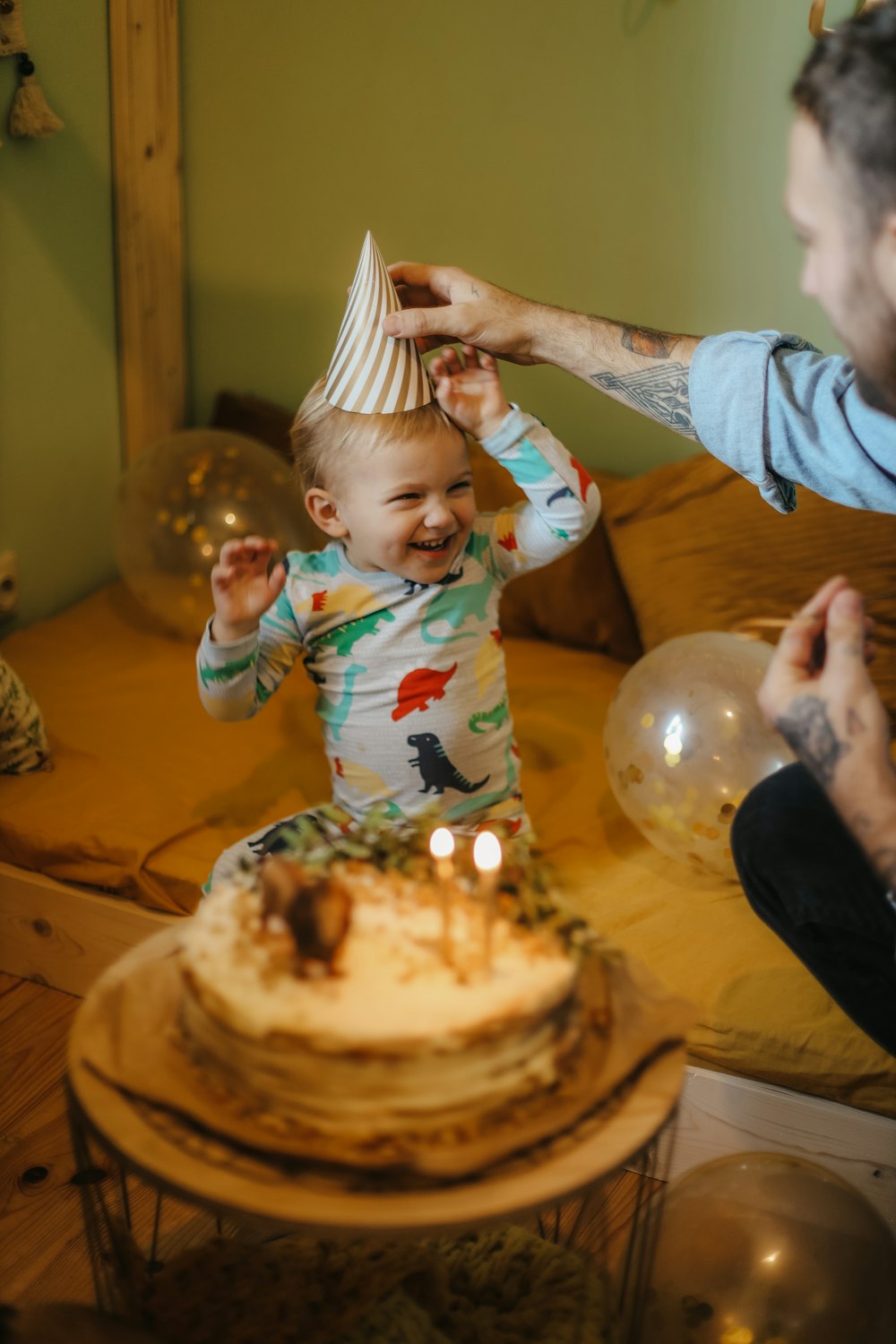 a person and a baby blowing out candles on a cake