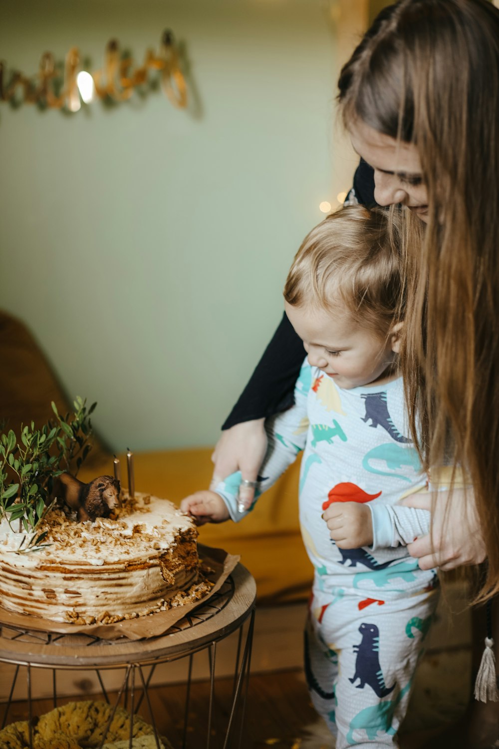 a person and a child blowing out candles on a cake