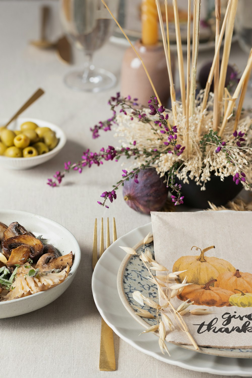 a table with plates of food and glasses