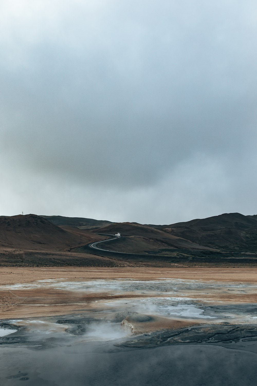 a beach with a hill in the background