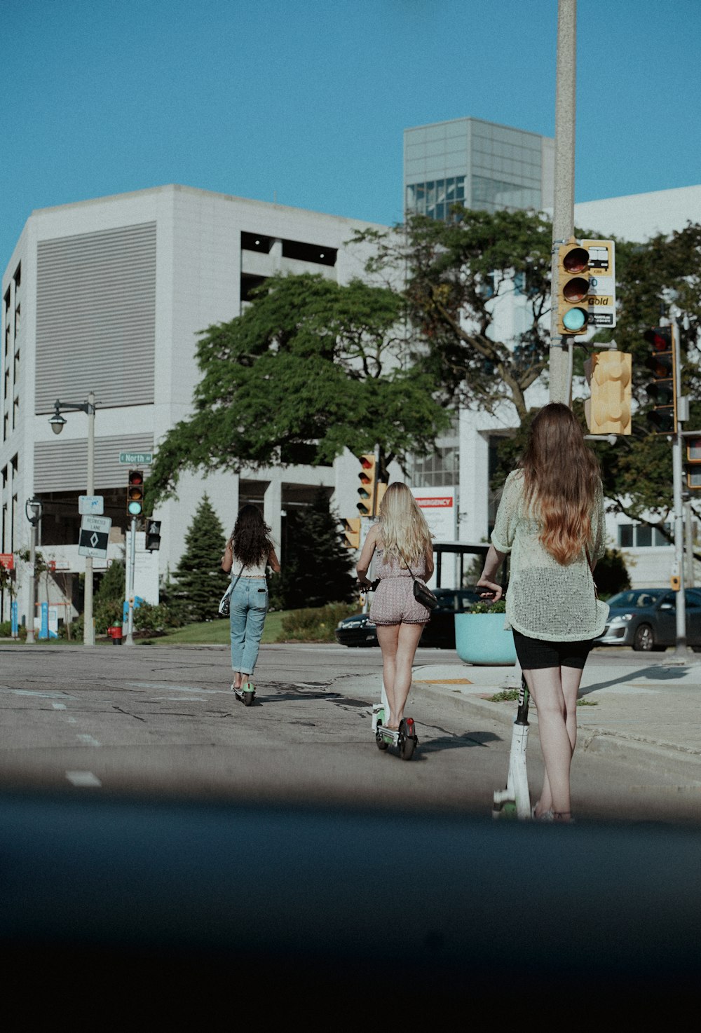 a group of women walking across a street