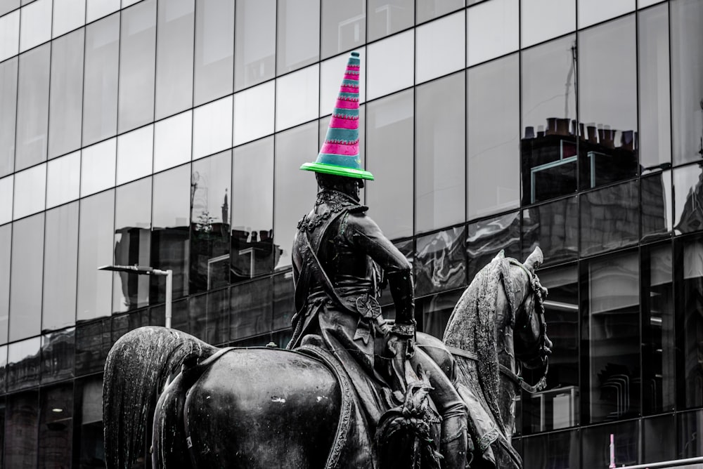 a statue of a person on a horse in front of a building