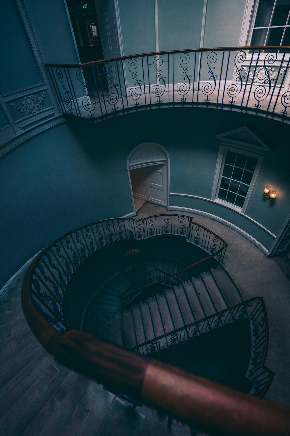 a hand holding a book in front of a balcony