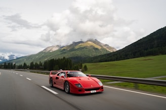 a red Ferrari driving on a road with high speed rated tyres sold in lagos