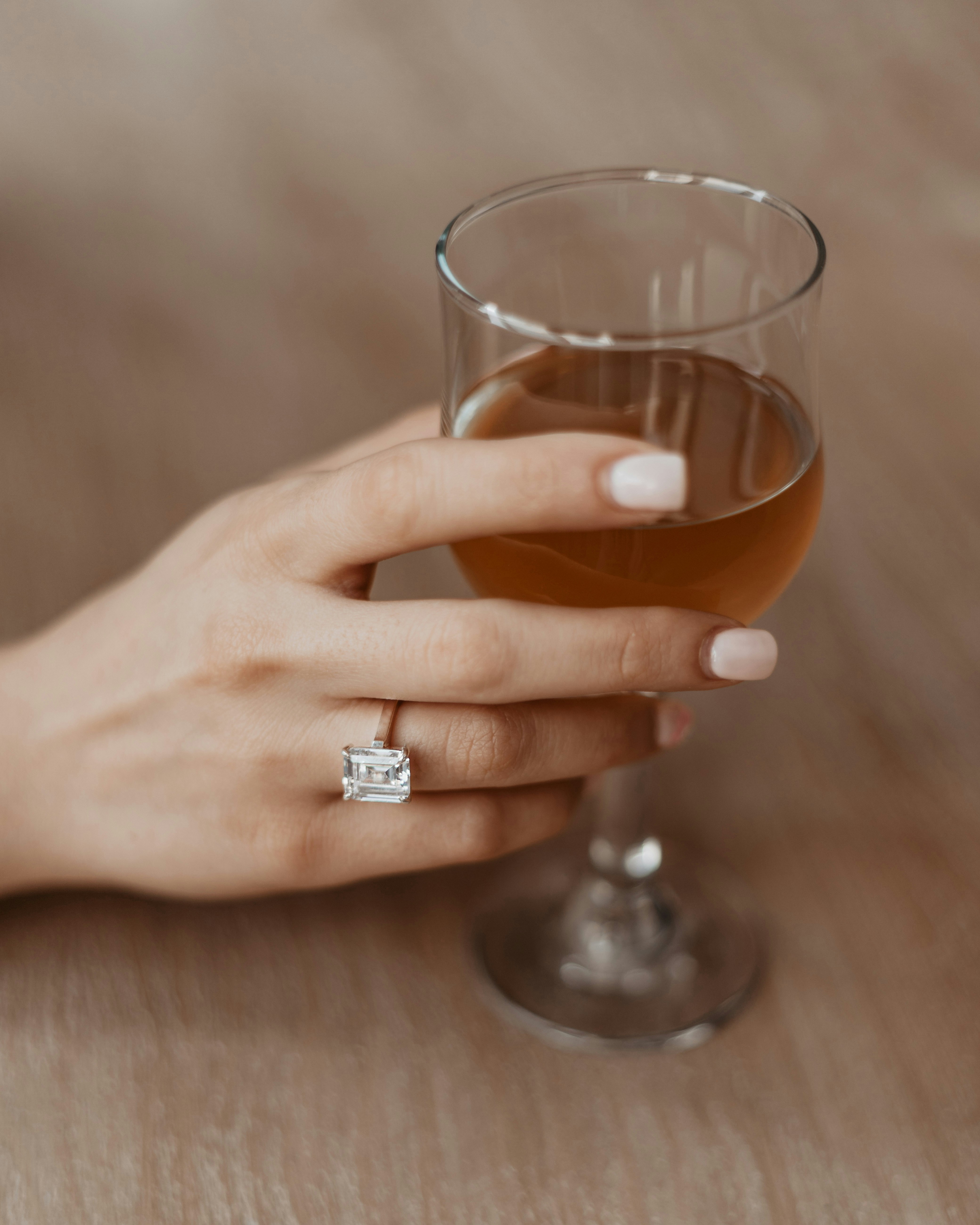 a hand holding a glass of wine