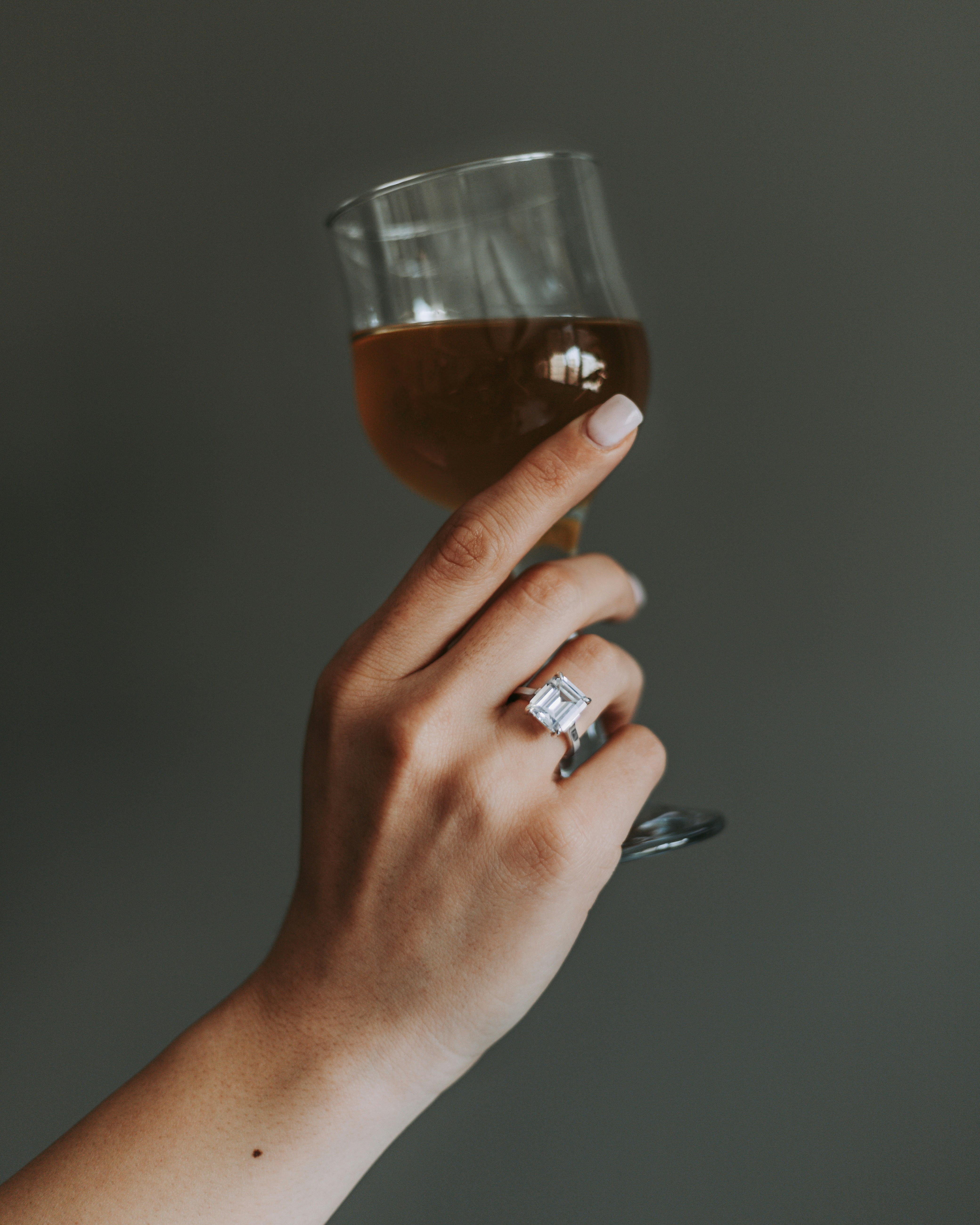 a hand holding a glass of beer