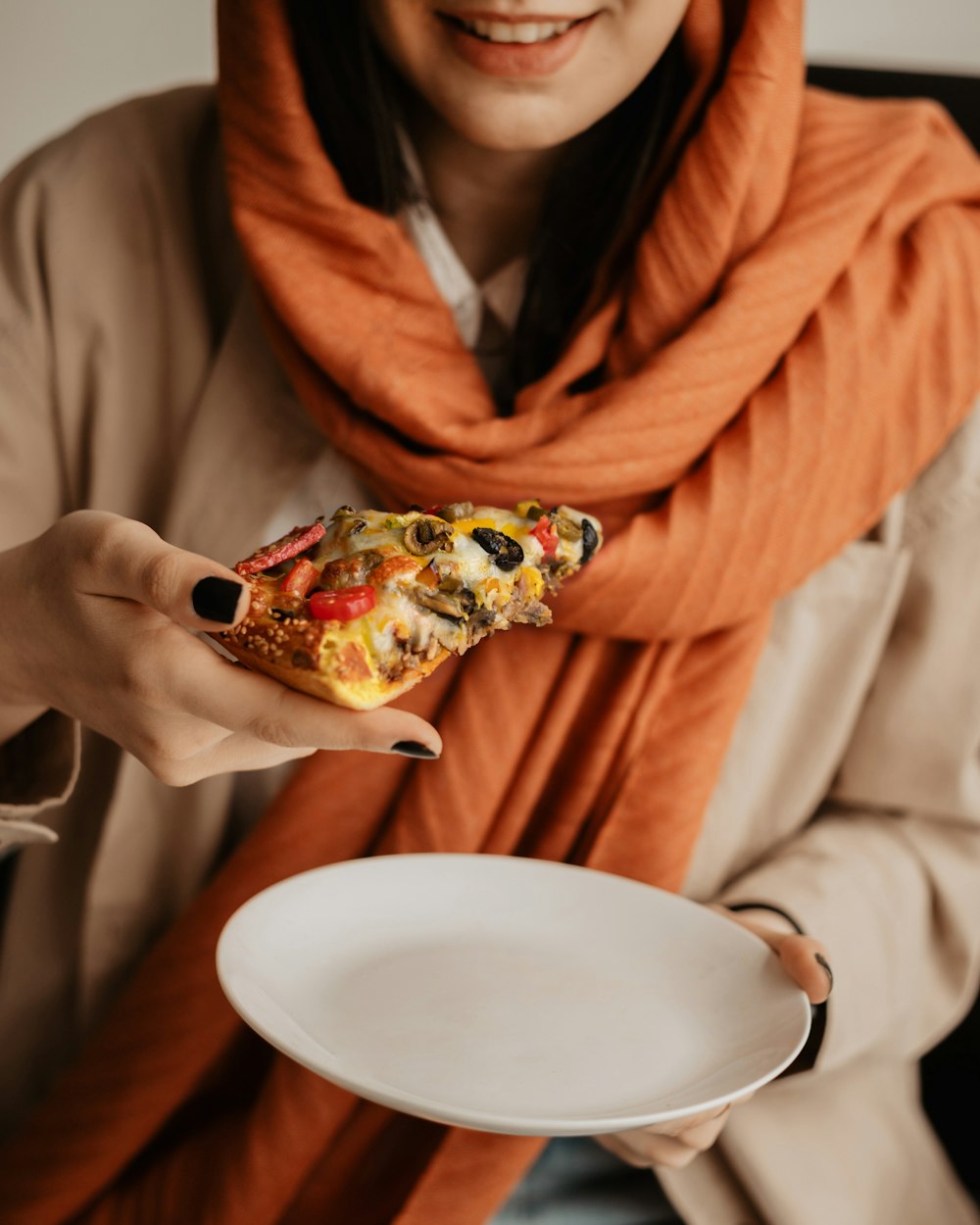 a woman holding a plate of food