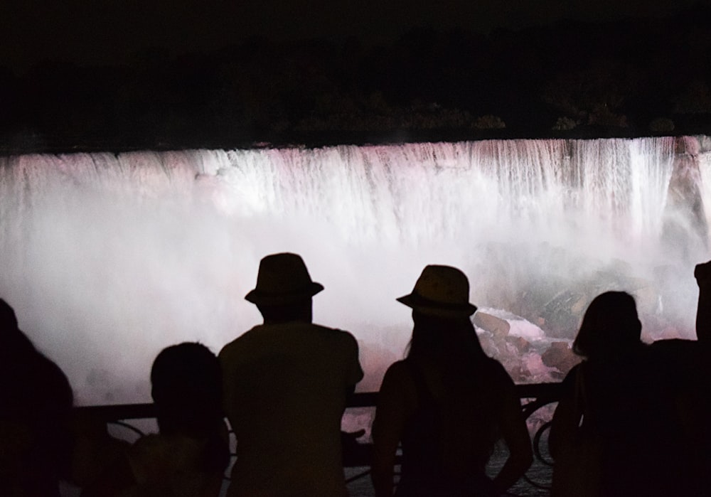 people looking at a waterfall