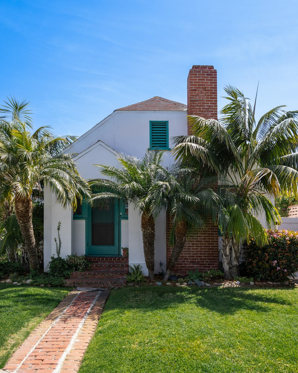 a white house with palm trees