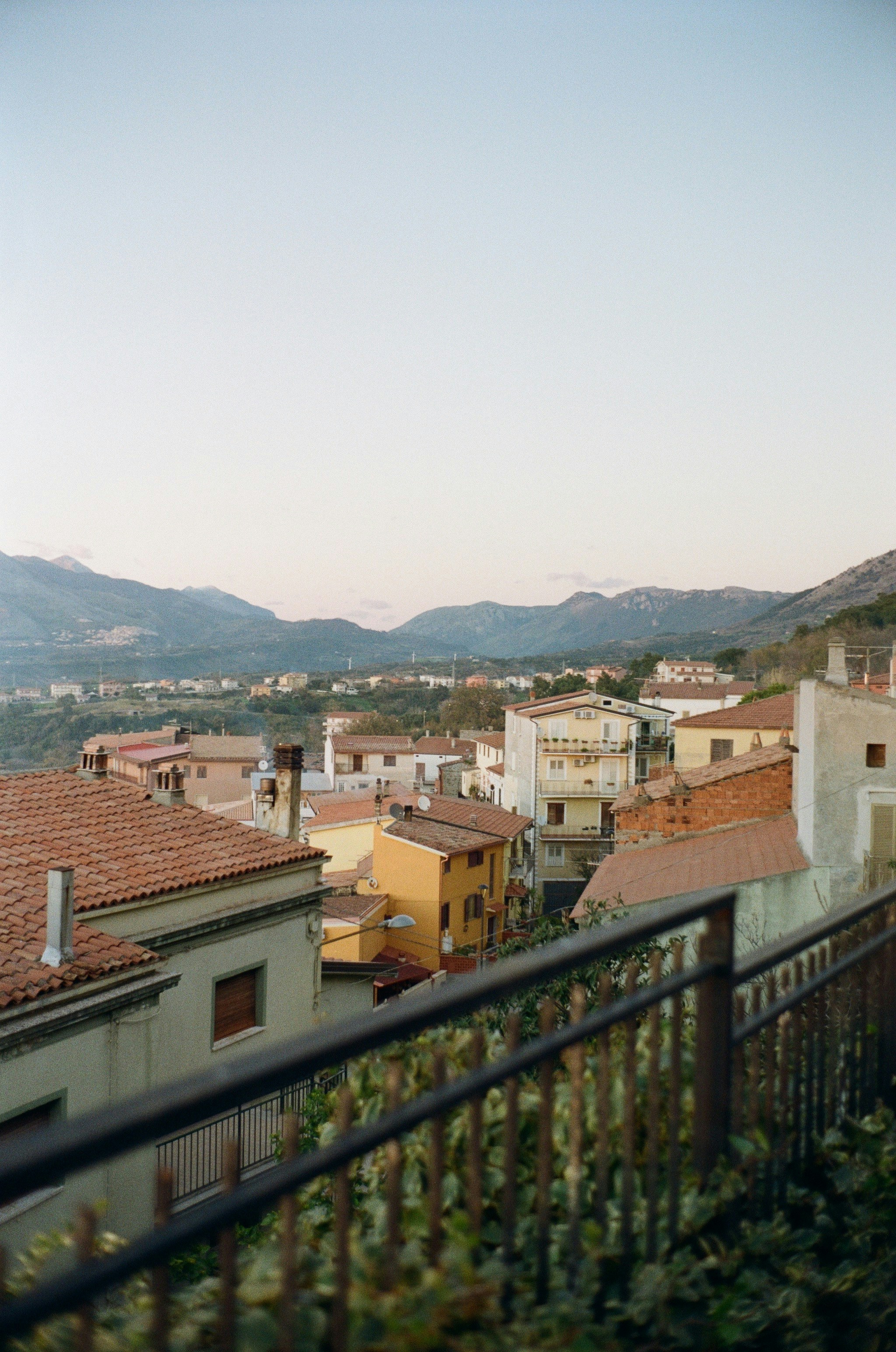 a group of buildings with mountains in the background