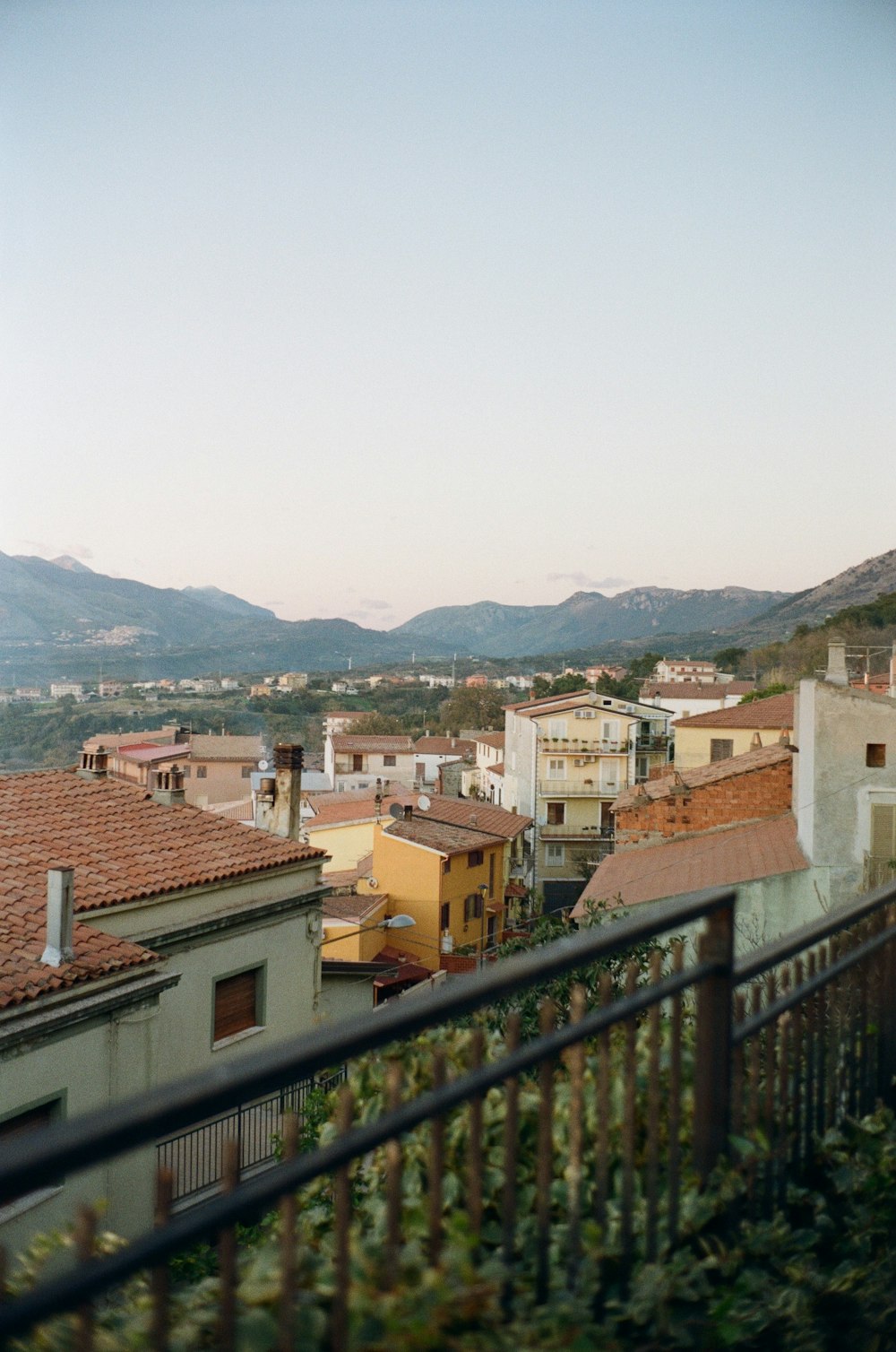 a group of buildings with mountains in the background