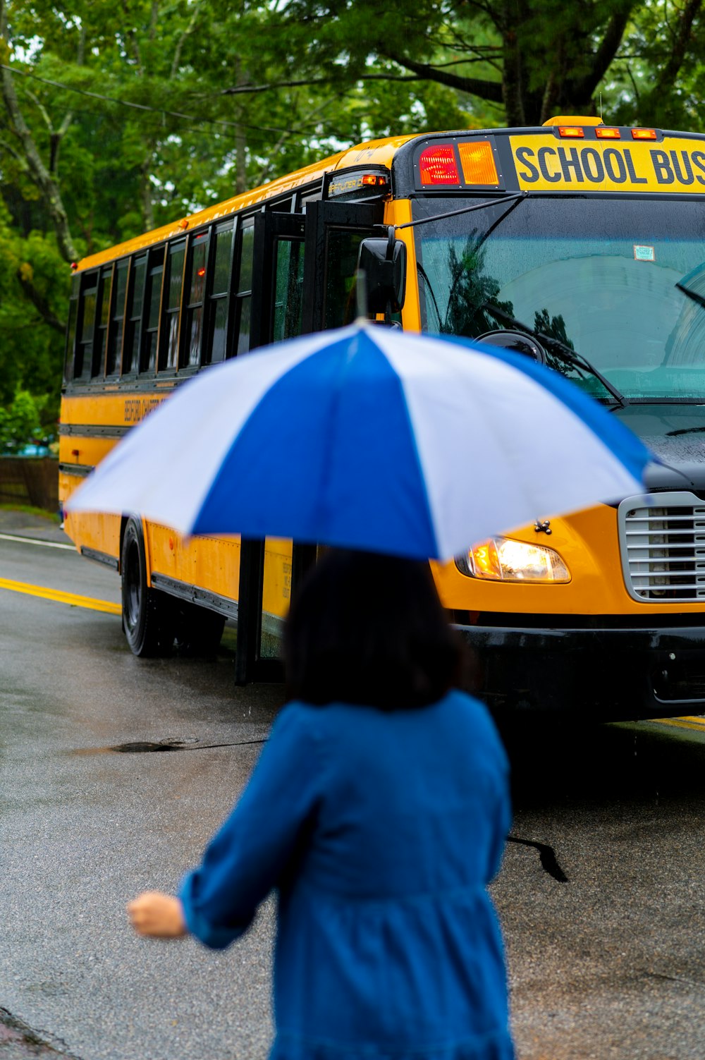 a girl stands under an umbrella