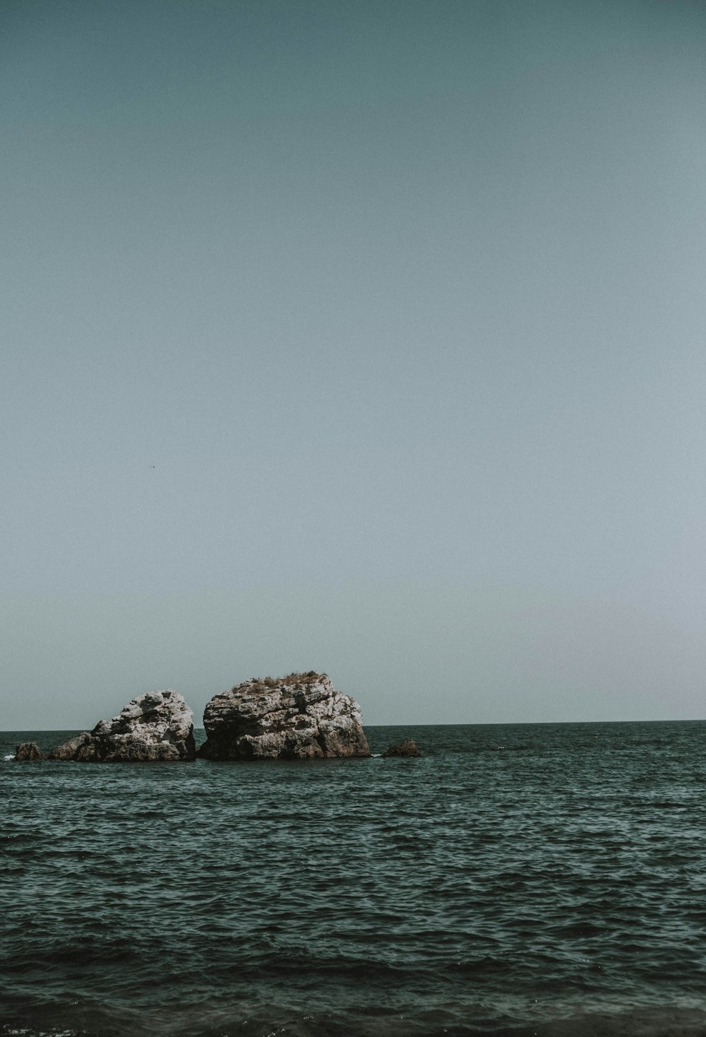 a group of rocks in the water