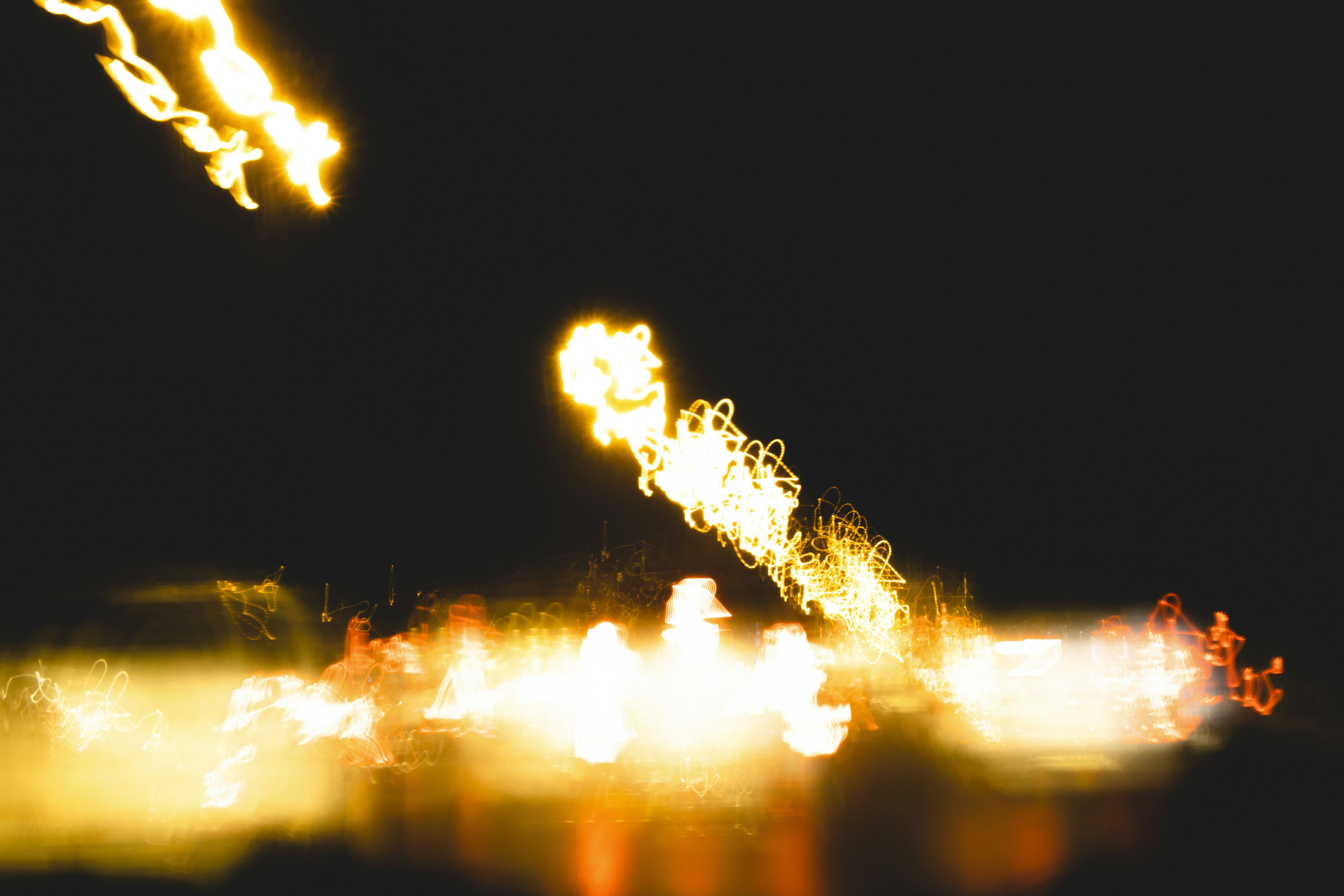 Dark abstract music visual with gold light streaks on black background