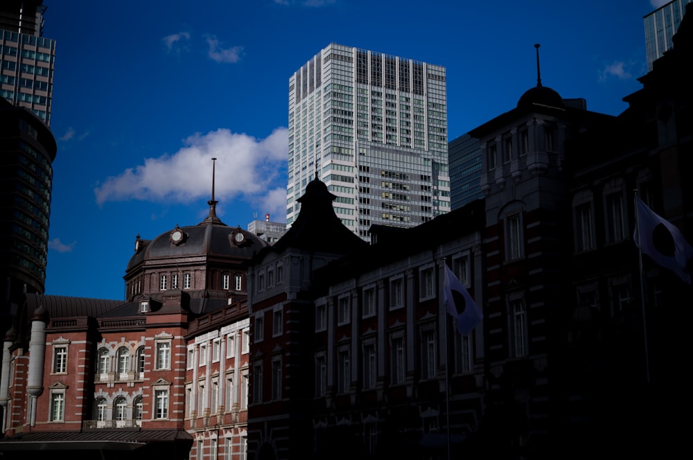 a group of buildings with flags in front of them