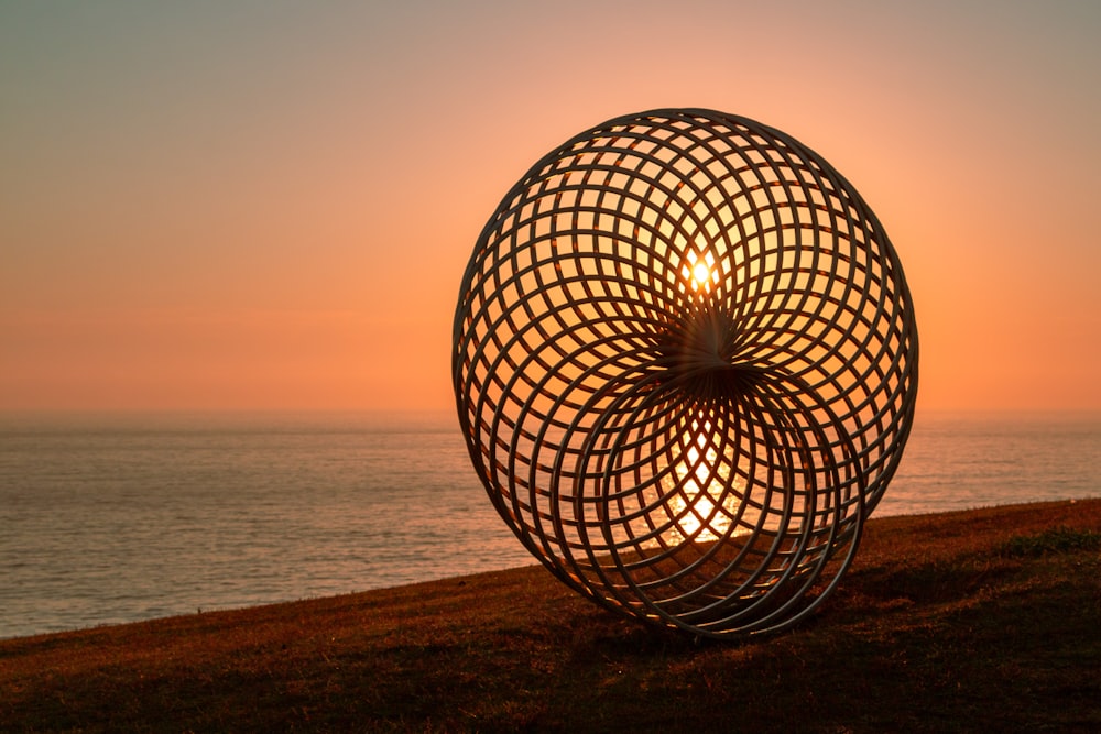 a sphere with lights on a beach