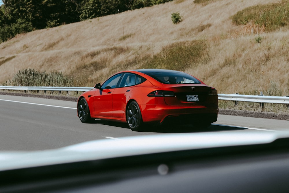 a red sports car on a road