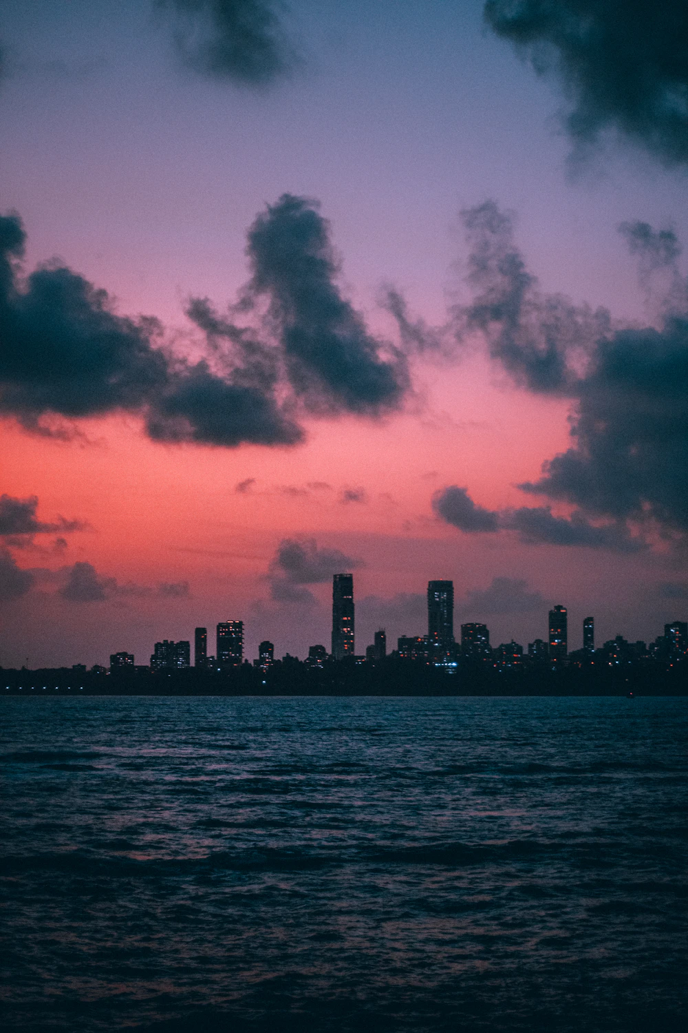 Mumbai skyline along Marine Drive at sunset