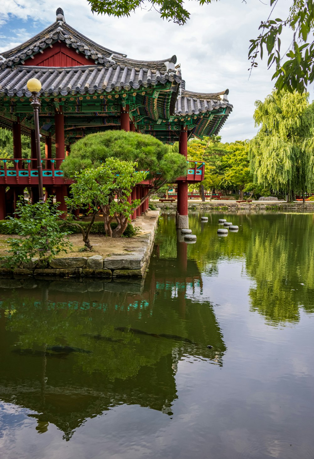 a building with a pond in front of it