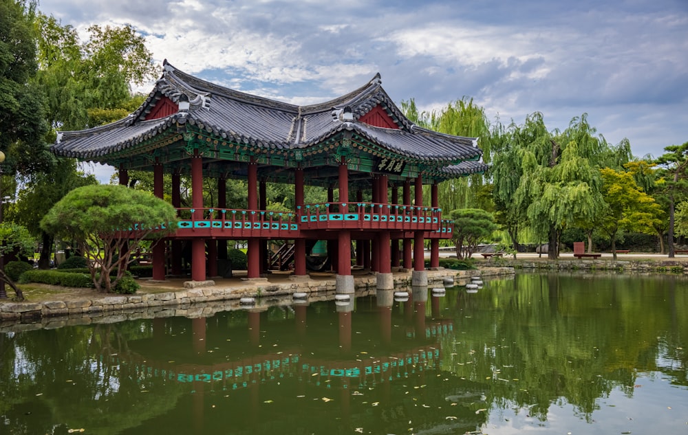 a building with a red roof surrounded by water