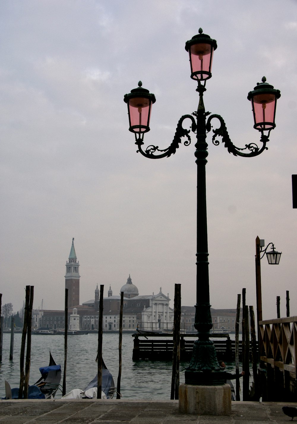 a light post with a body of water in the background