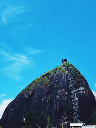 a large rock formation with a tower