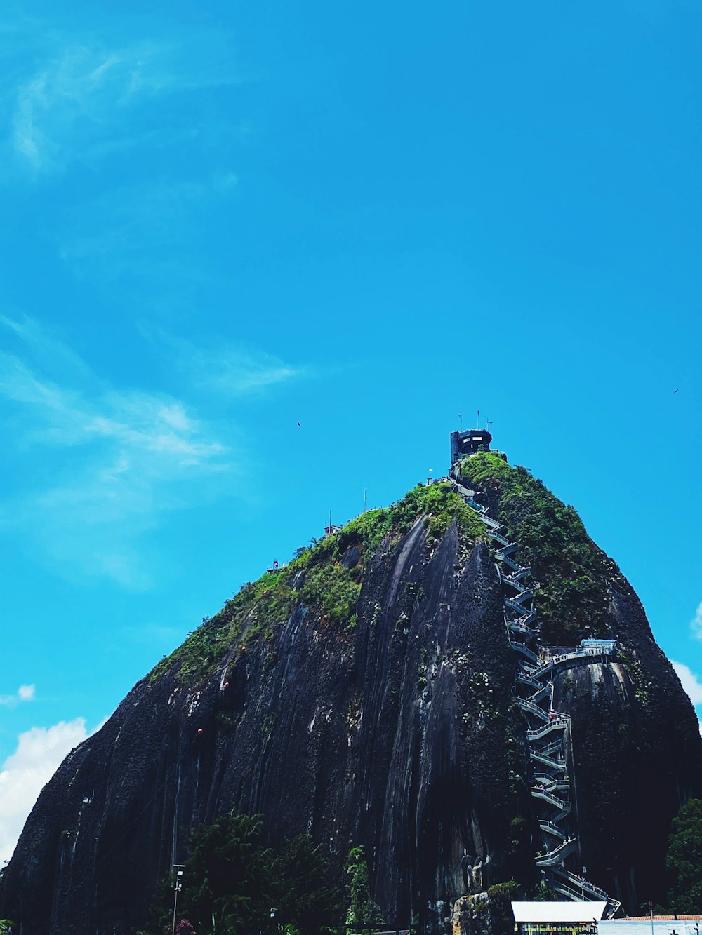 a large rock formation with a tower