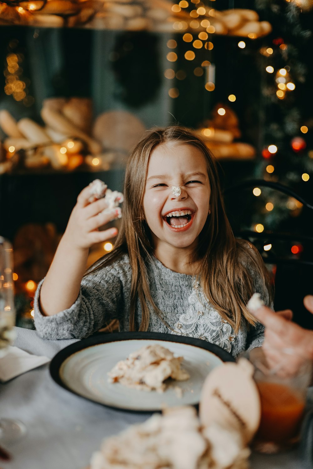 a woman laughing and eating food