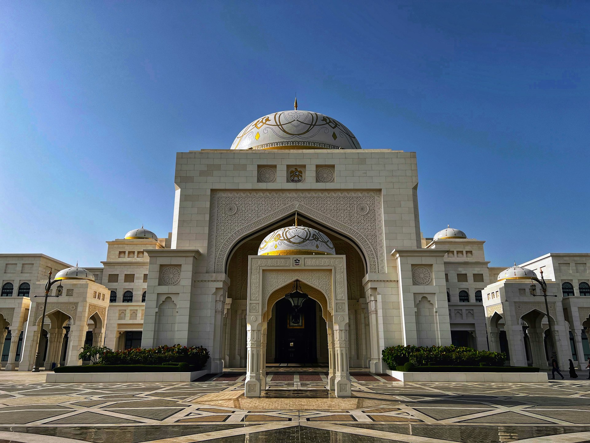 a large white building with a domed roof and a gold dome