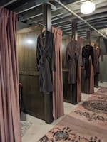 a room with a row of clothes on the wall