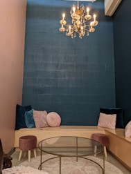 A cozy meeting space with soft teal walls and coral cushions.