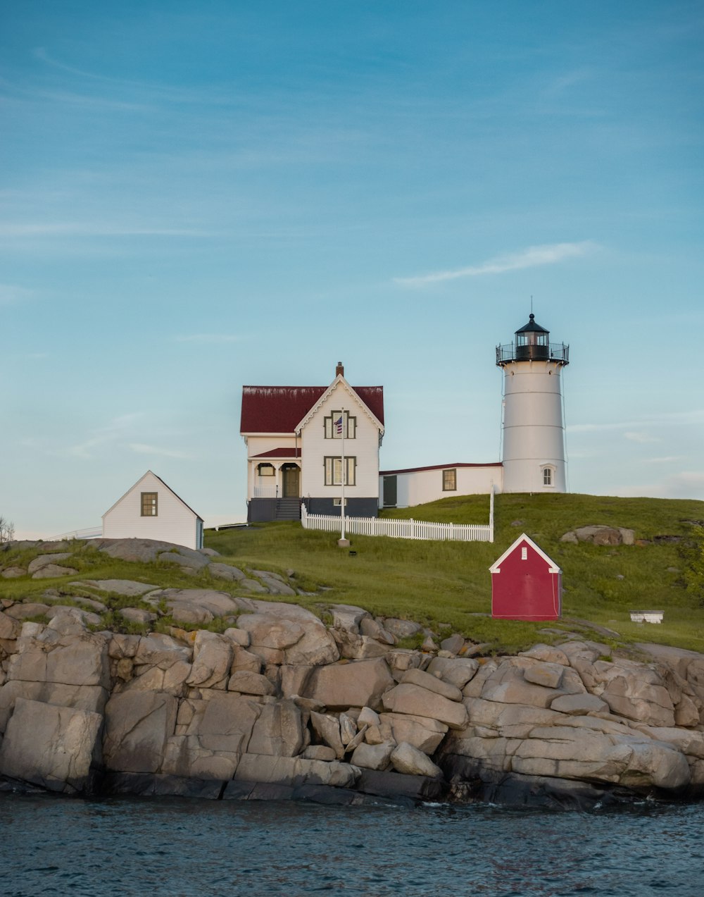 a lighthouse on a rocky hill