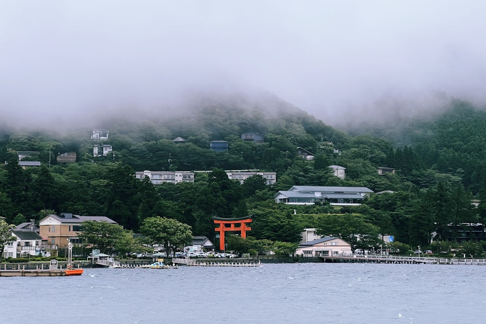 a body of water with buildings and trees around it