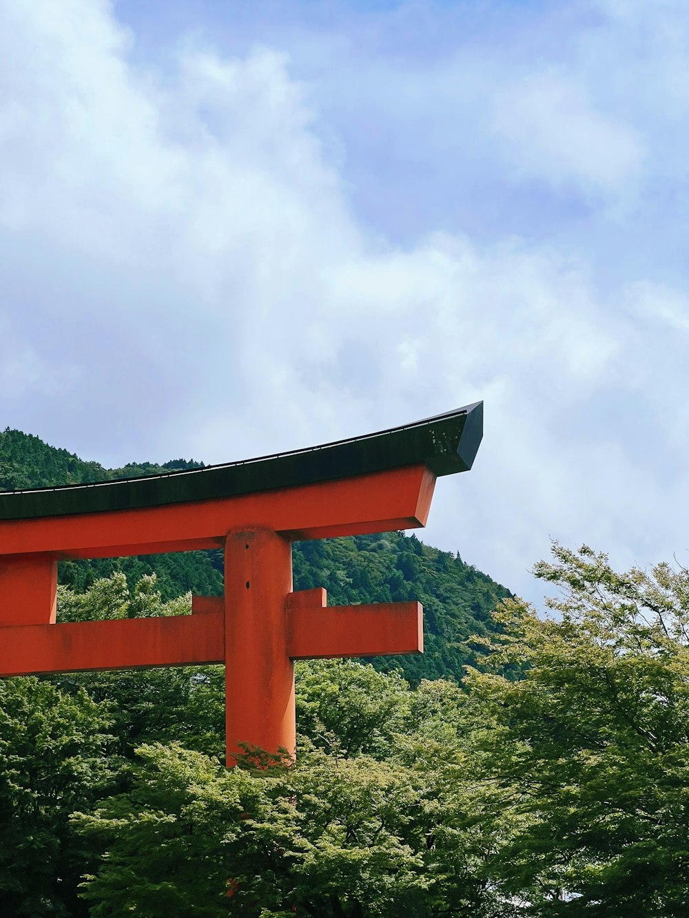 a red wooden structure surrounded by trees